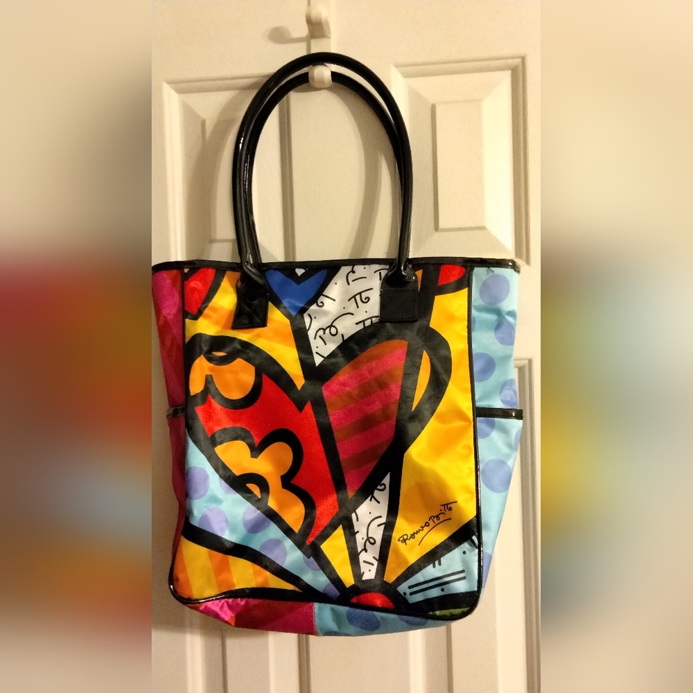 This is a Romero Britto "A New Day" heart tote bag, Made Of Satin/Polyester.